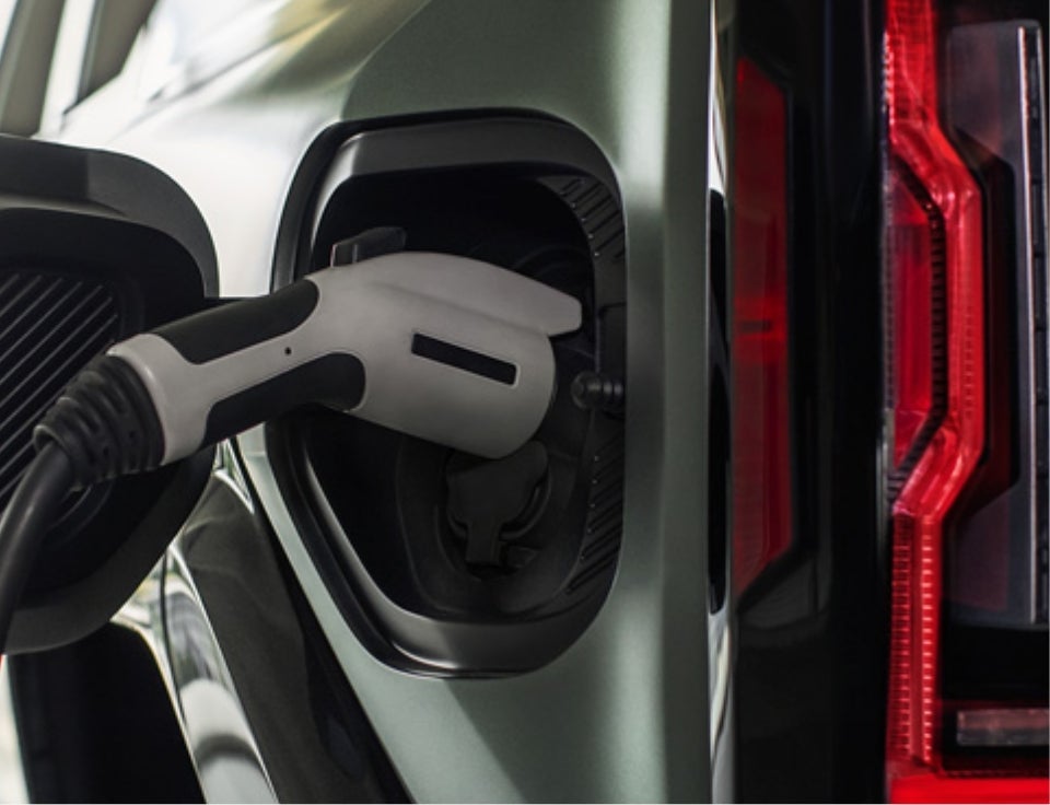 Close up of charging port with charger plugged in on a GMC Hummer EV SUV - Andy Mohr Buick GMC in Fishers IN